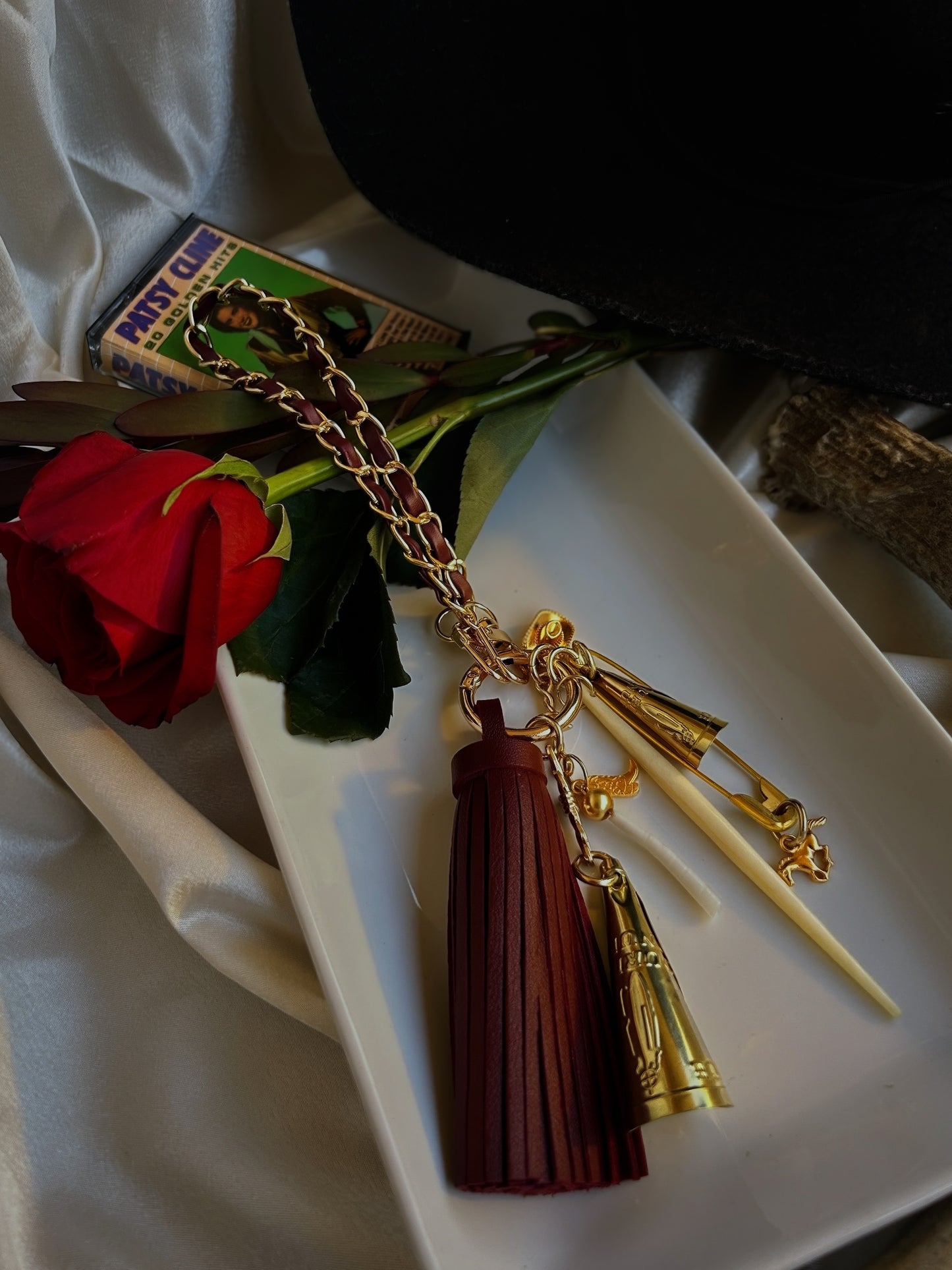 Cowboy, Take Me Away wristlet keychain adorned with charms, jingles, dentalium, and a bone spike