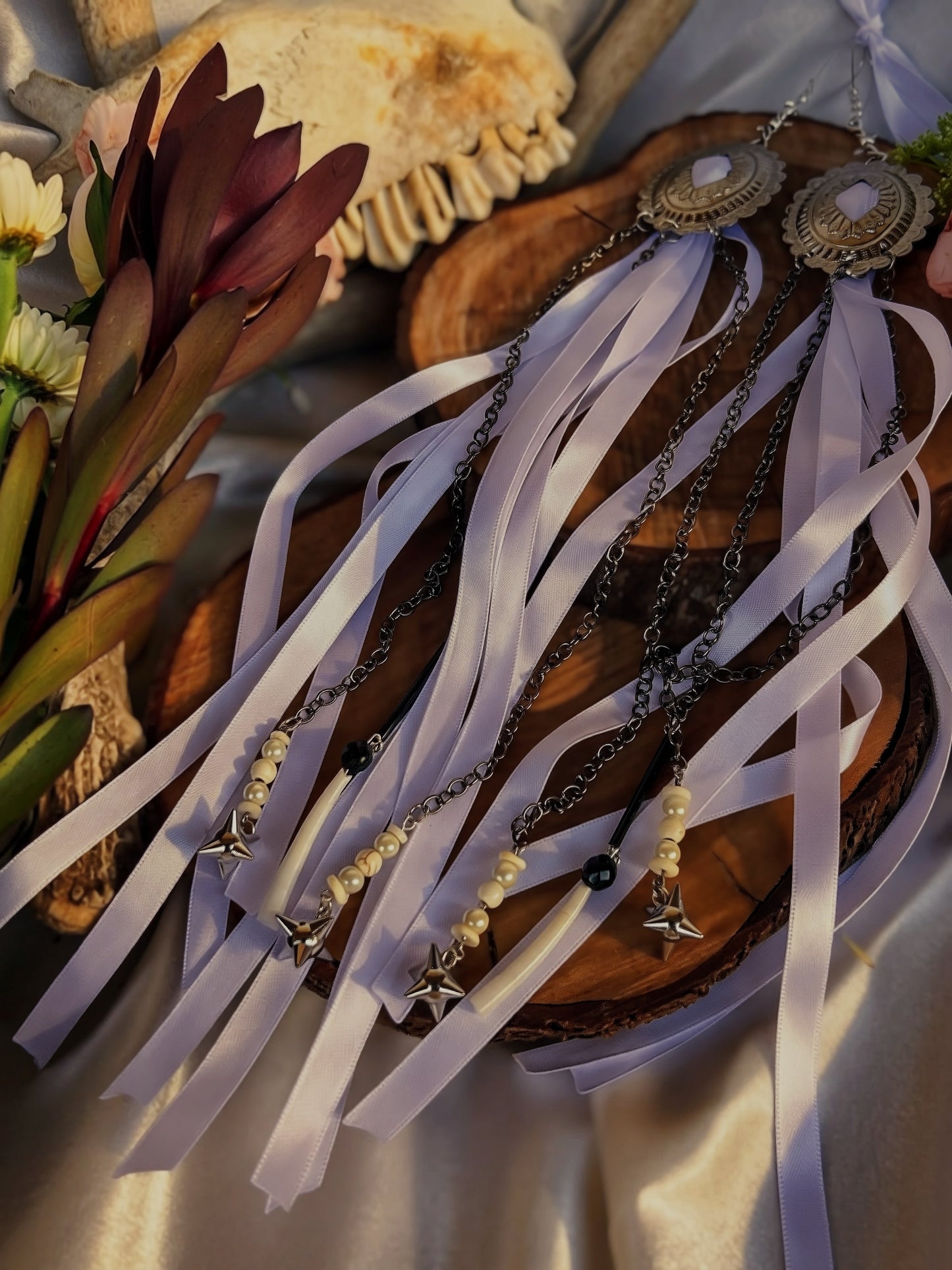 Concho ribbon earrings featuring larger dentalium shells and metal flail charms