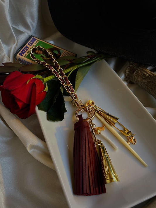 Cowboy, Take Me Away wristlet keychain adorned with charms, jingles, dentalium, and a bone spike